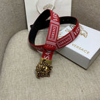 Red Versace belt with gold Medusa buckle and black reverse strap