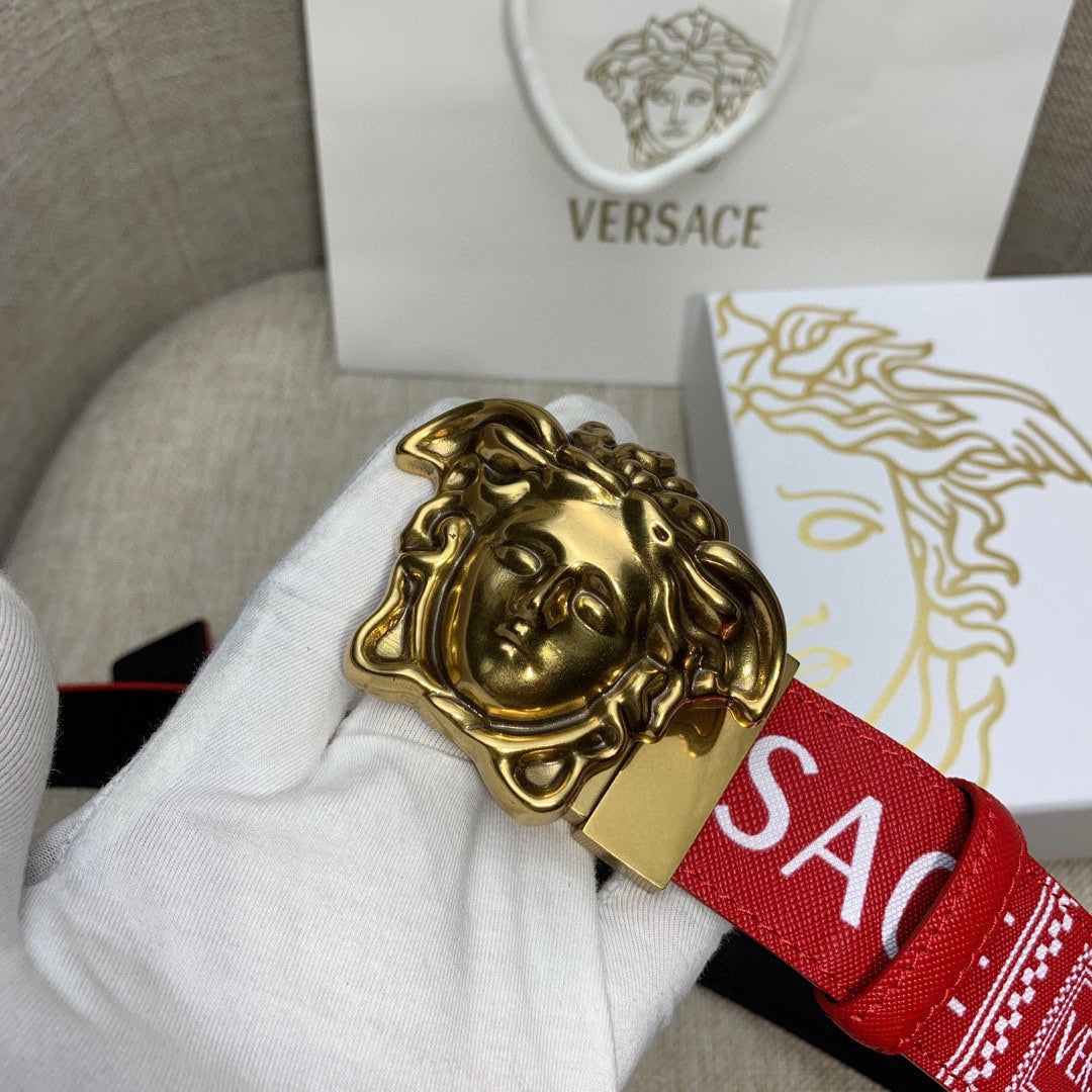 Red Versace belt close-up: gold Medusa buckle on logo strap