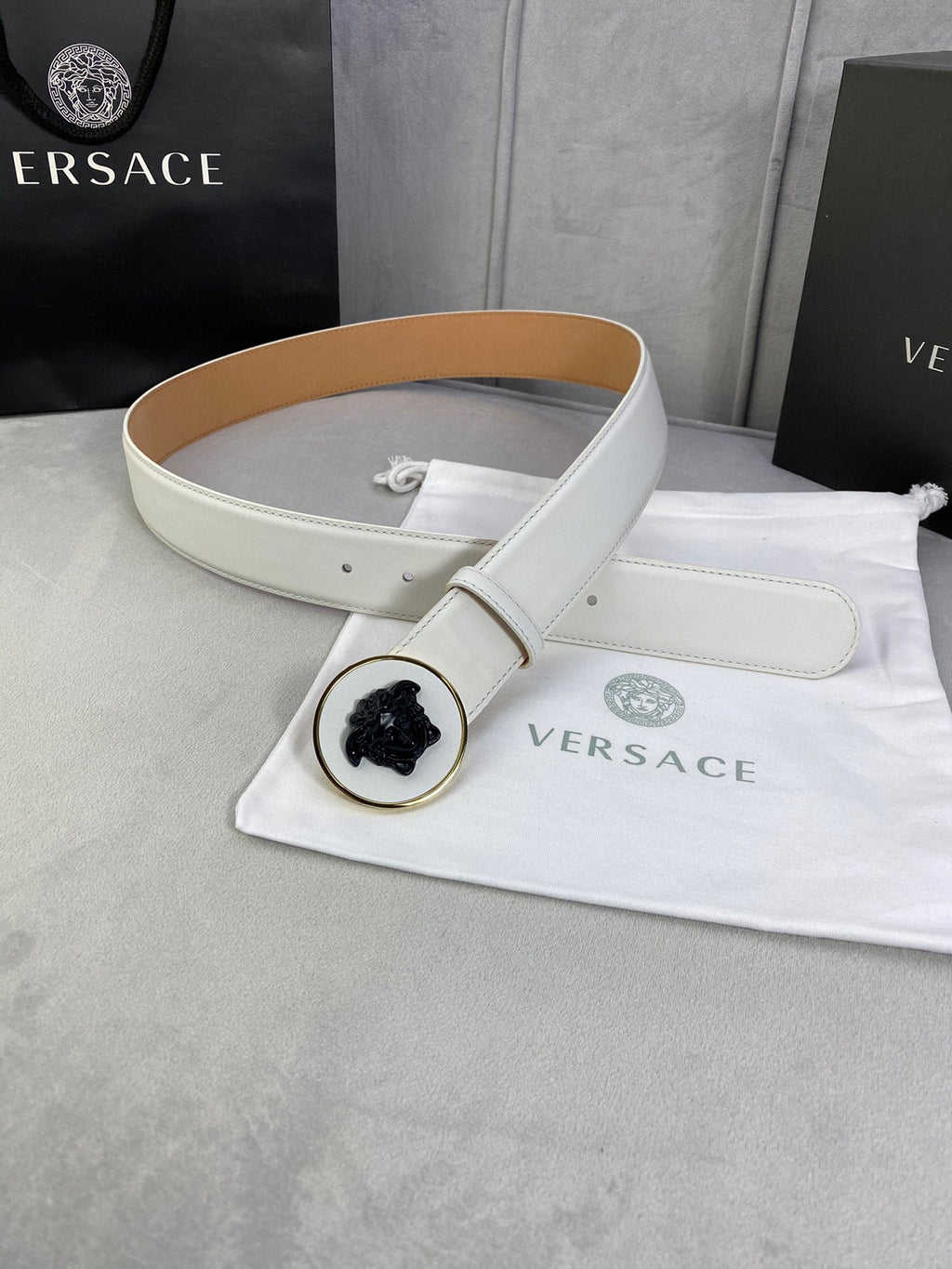 Versace belt with white leather strap, round Medusa buckle and adjustable end.