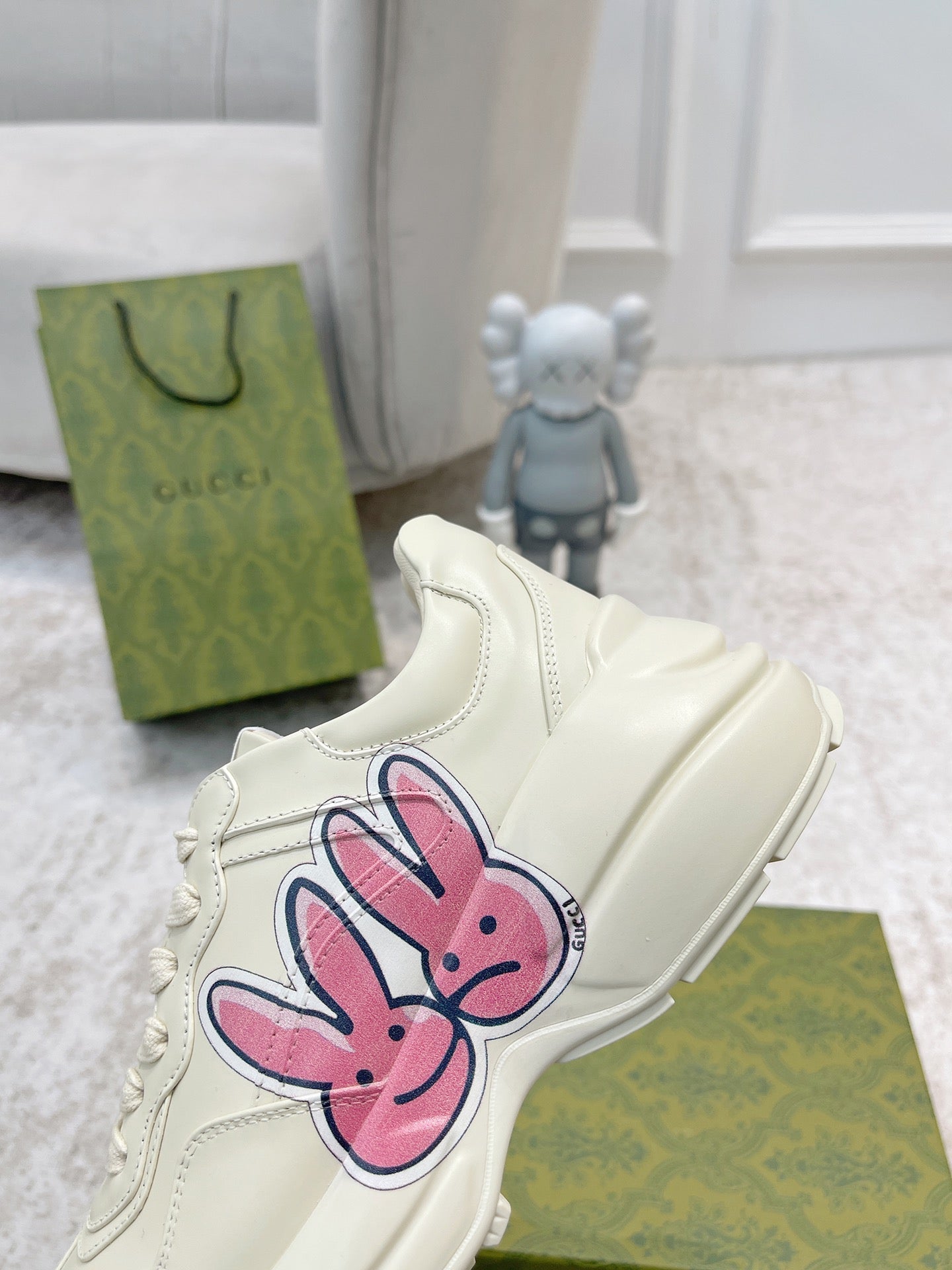 White sneaker close-up with pink-and-blue bunny graphic on the side panel