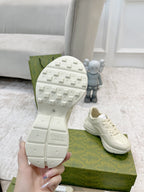 White sneaker outsole with grid tread, lace-up upper partially visible