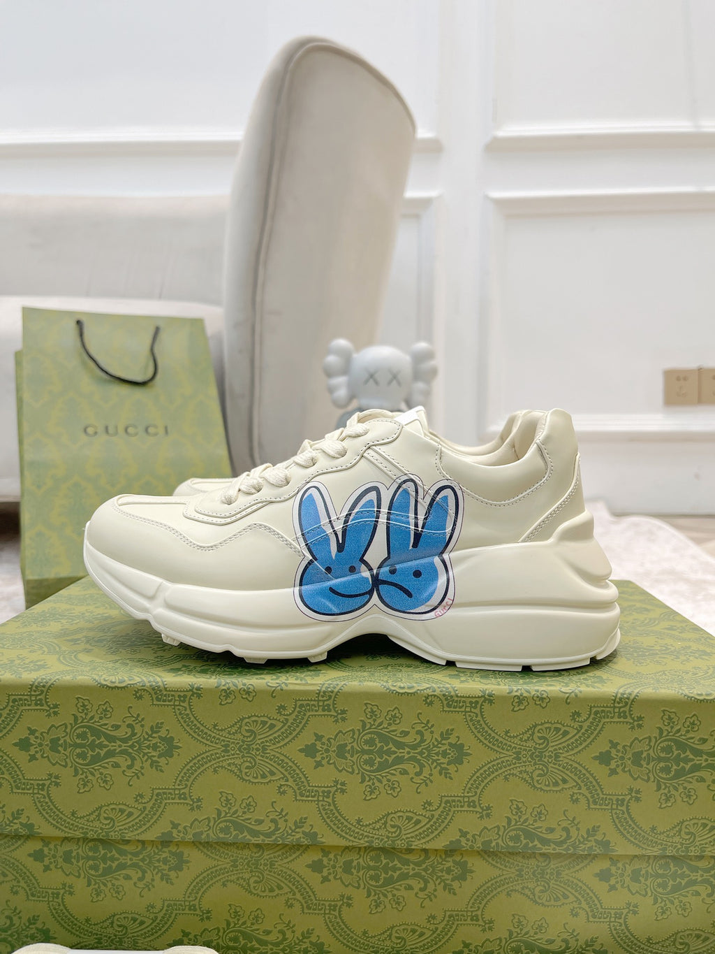 White lace-up sneakers with blue bunny logo on the side, low-top style