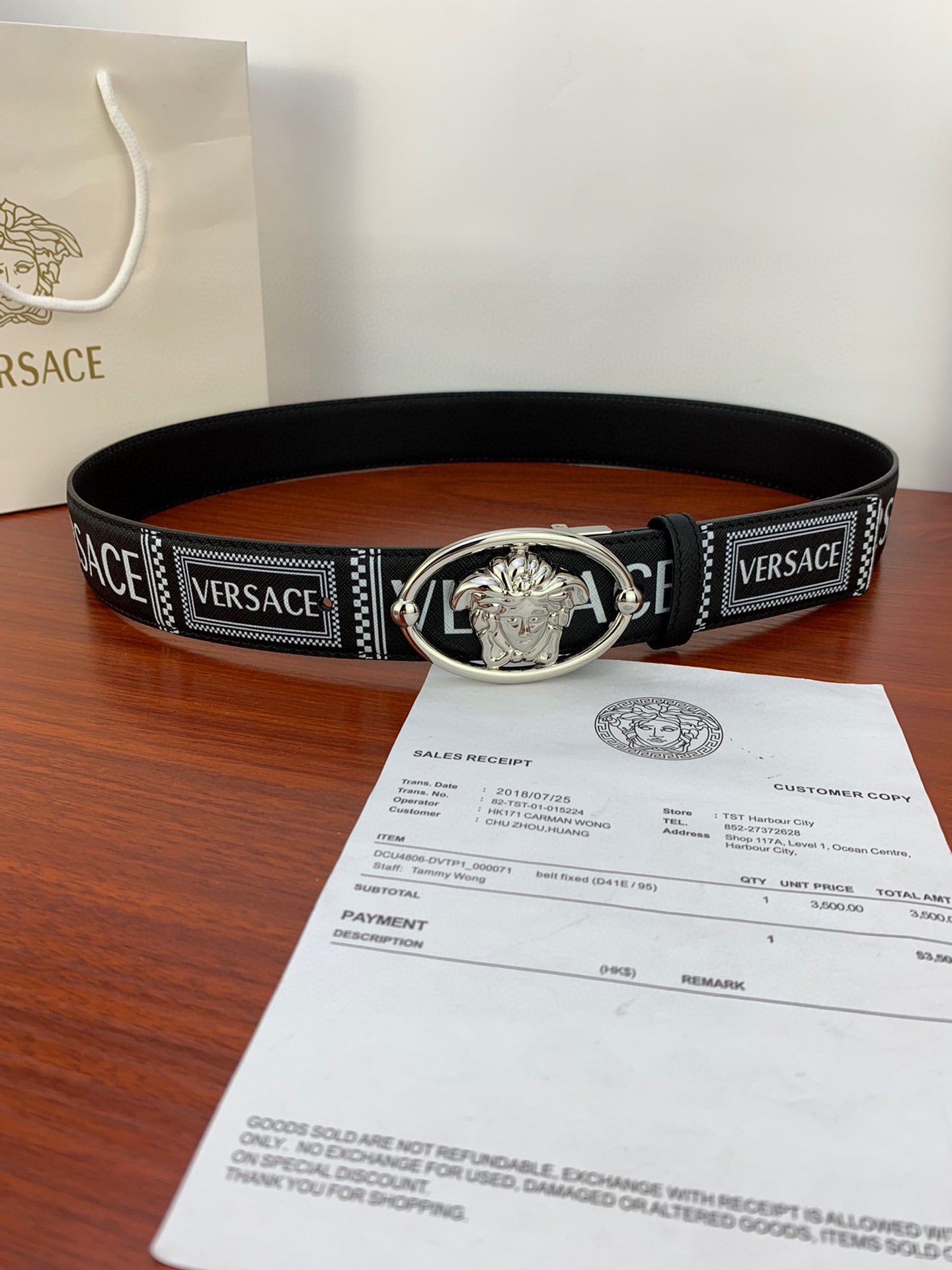 Versace belt on box: black strap with silver oval buckle and logo detail