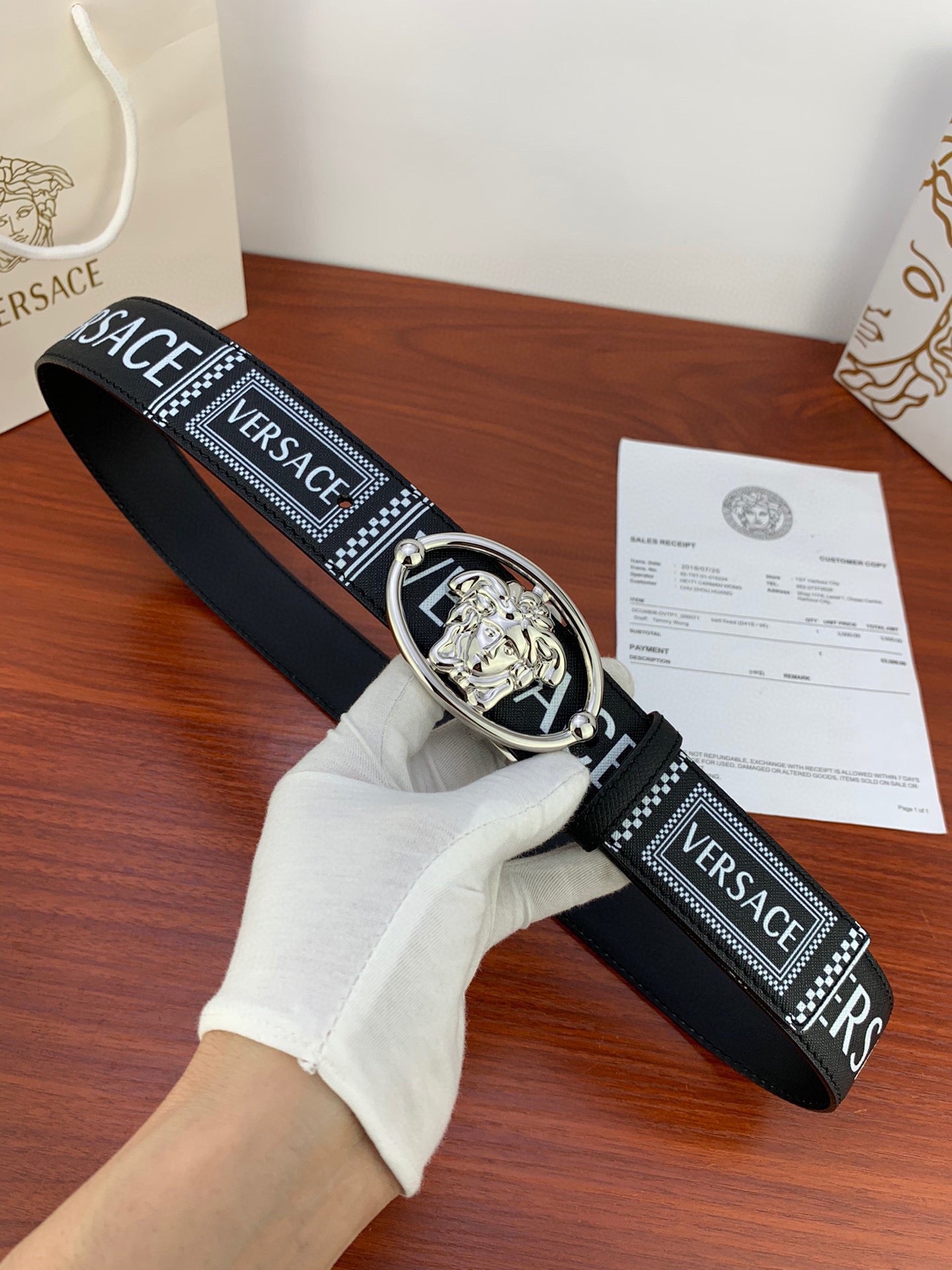 Versace belt in black with silver oval buckle and logo-pattern strap