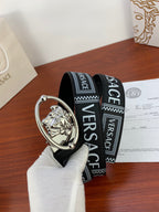 Versace belt featuring black logo strap and silver oval buckle with relief emblem