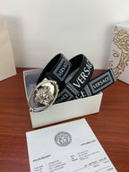Versace belt on box: black strap with silver oval buckle and VERSACE logo bands