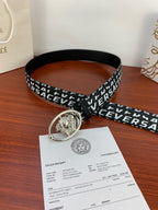 Black Versace belt with repeating white logo and silver Medusa oval buckle, angled