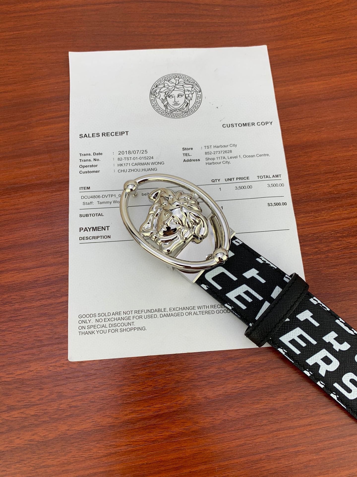 Black Versace belt with repeating white logo strap and silver Medusa oval buckle