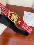 Versace belt with black leather backing and red logo strap featuring gold Medusa buckle.