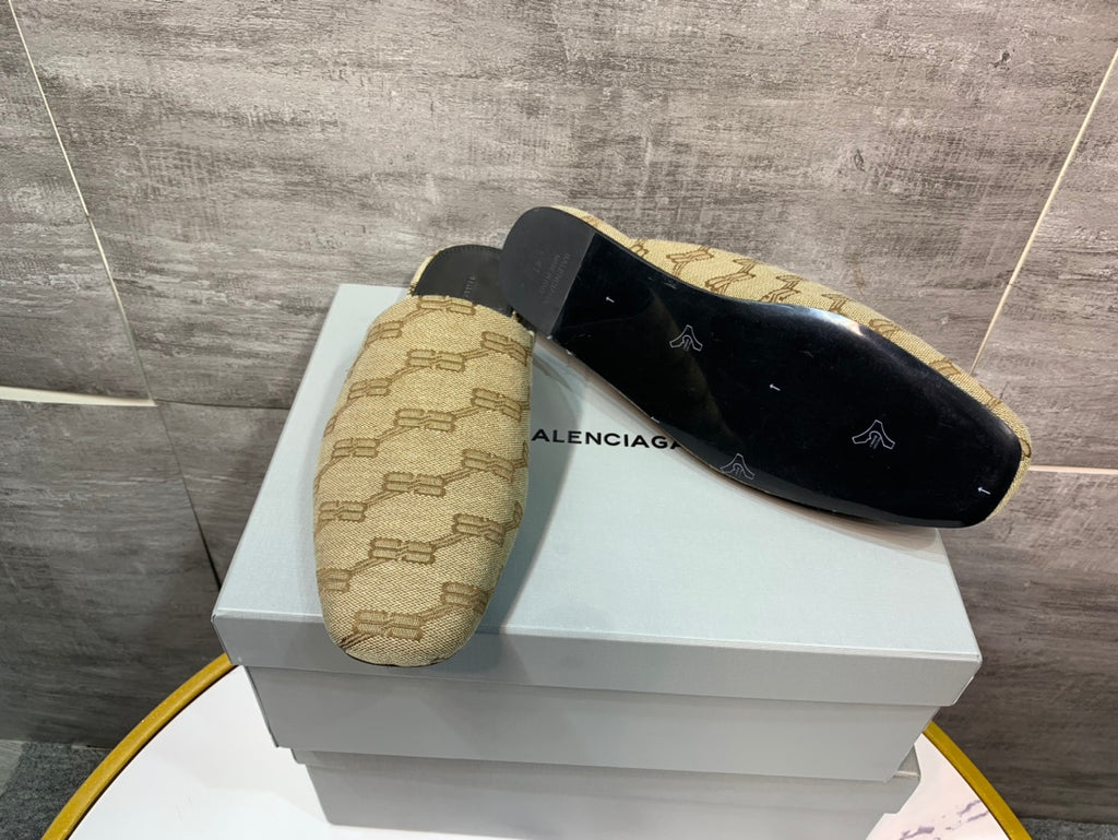 Beige patterned slide sandals with black insoles, pair on white display box