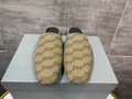 Beige patterned slide sandals on a white box, black insoles visible