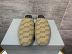 Beige patterned slide sandals on a white box, black insoles visible
