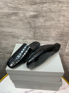 Black croc-embossed slide sandals with BB logo, shown on box