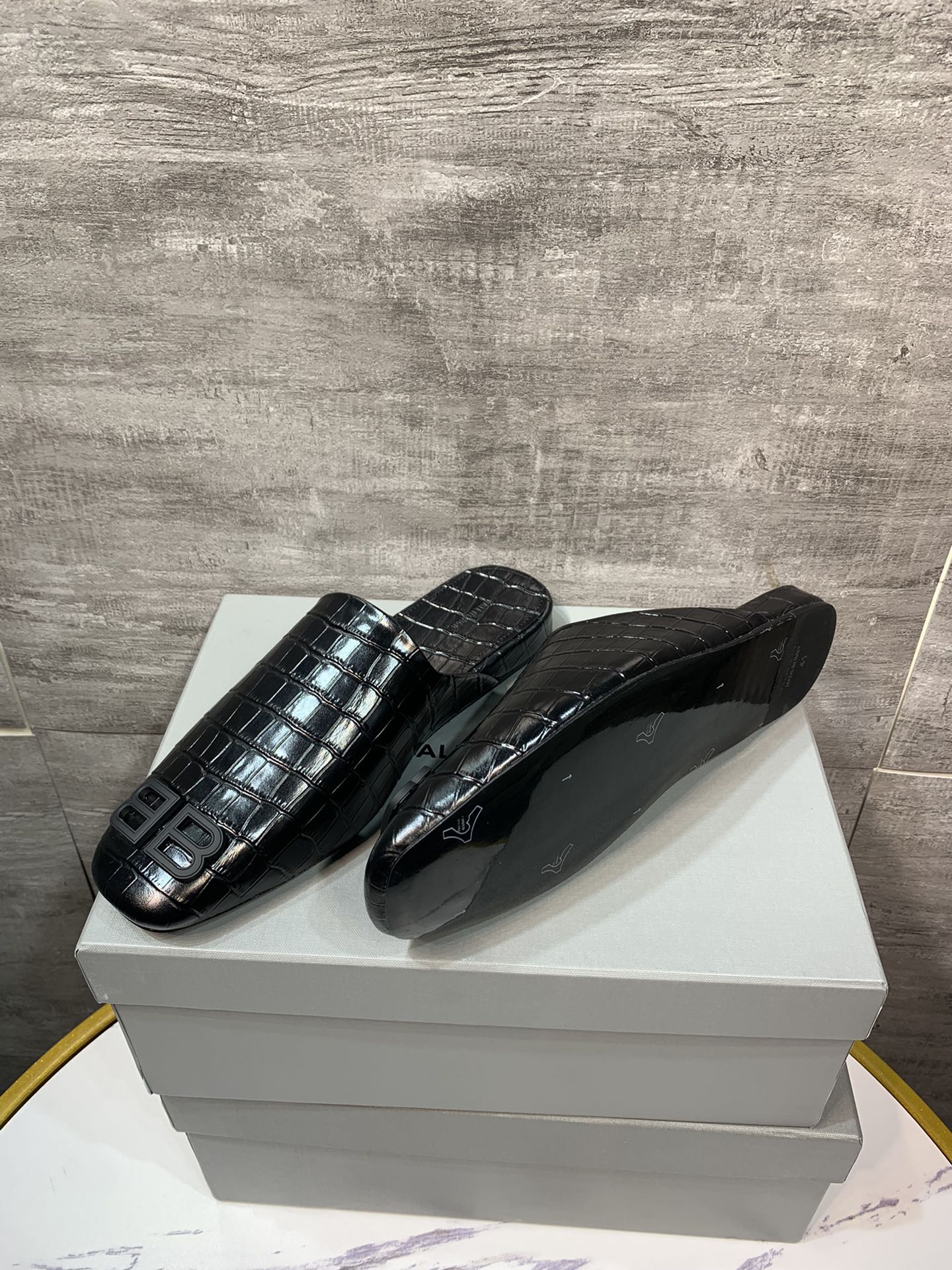 Black croc-embossed slide sandals with BB logo, shown on box