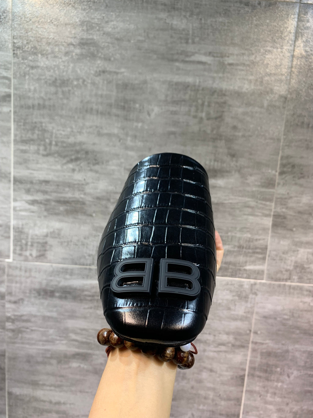 Black croc-embossed slide sandal with BB logo front, held up