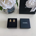 Chanel earrings in navy gift boxes, gold-tone CC logo stud pair