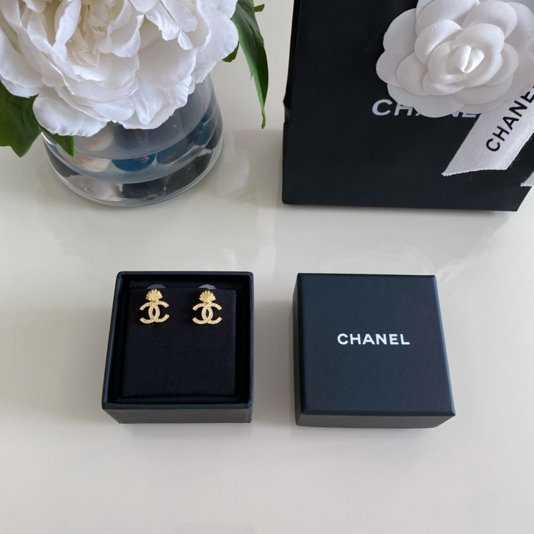 Chanel earrings in navy gift boxes, gold-tone CC logo stud pair