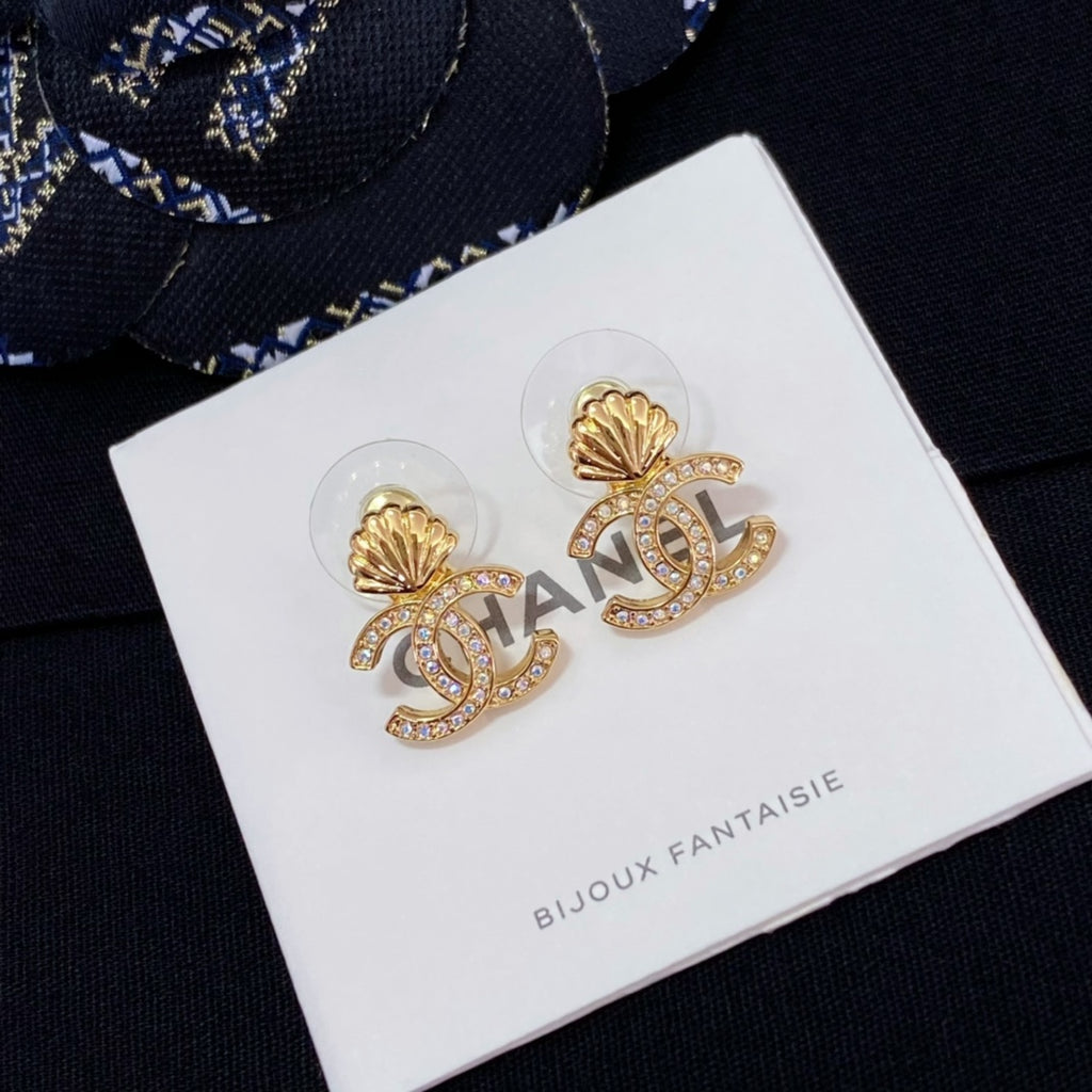 Chanel stud earrings with gold-tone shell and CC logo, rhinestone accents