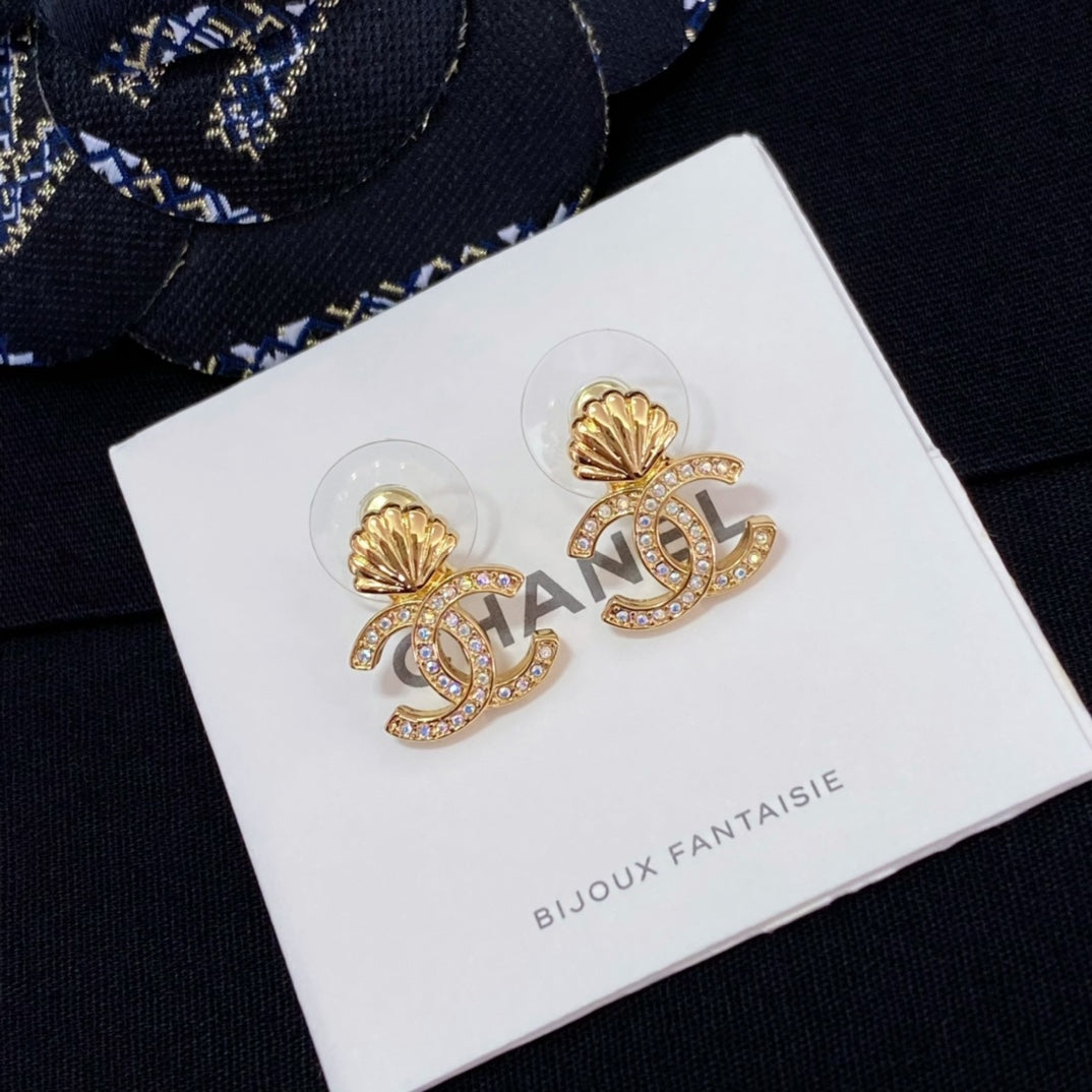 Chanel stud earrings with gold-tone shell and CC logo, rhinestone accents