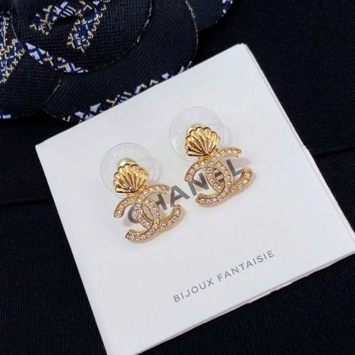 Chanel stud earrings with gold-tone shell and CC logo, rhinestone accents