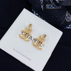 Chanel earrings with gold-tone CC and shell motif, front view