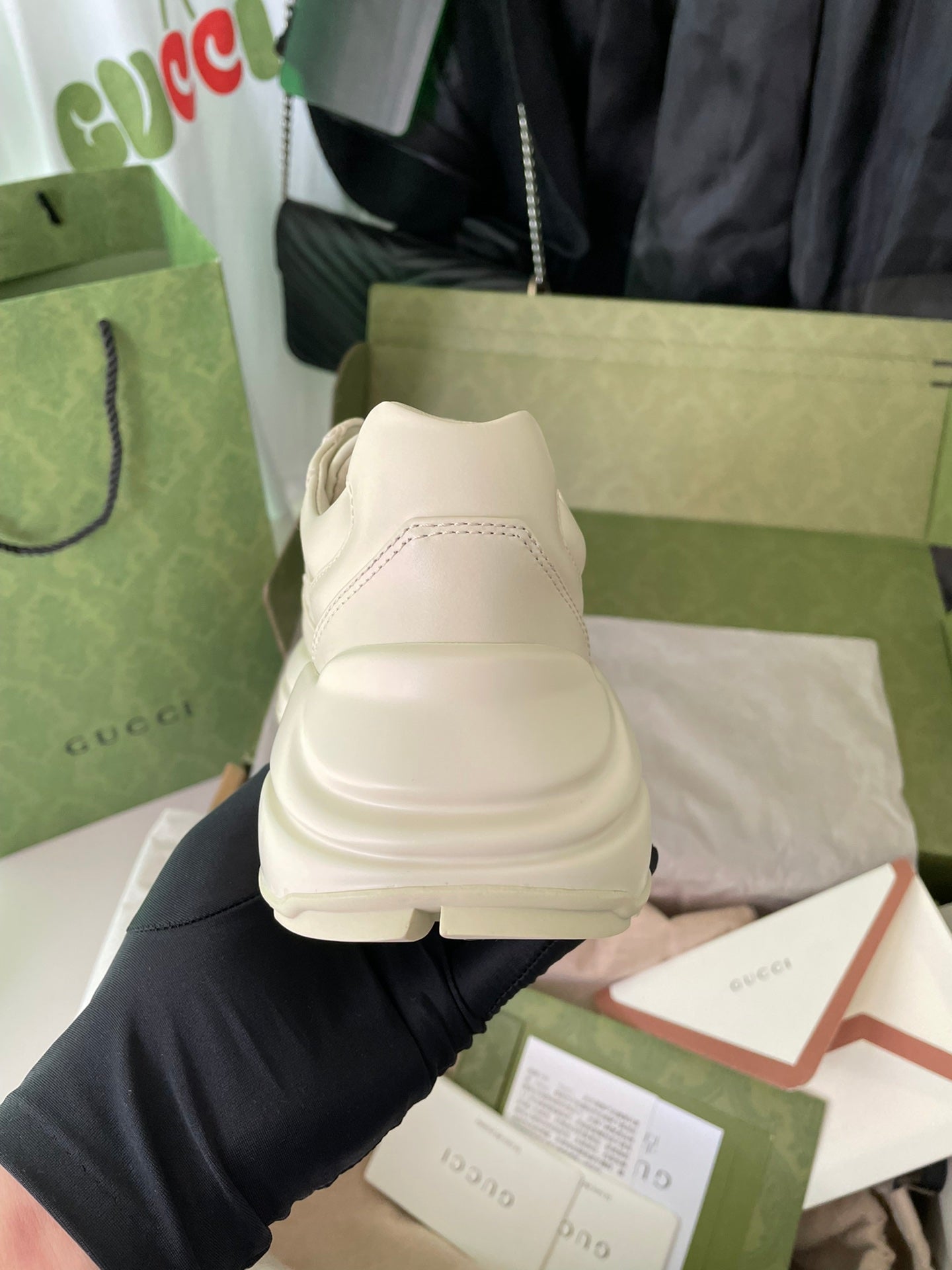 Cream Gucci sneakers with thick sole and back view; minimal branding.