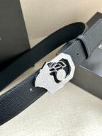 Versace leather belt, dark textured strap and large silver logo buckle close-up