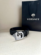 Black leather belt with silver-tone Medusa buckle and textured strap.