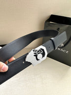 Dark blue leather belt with silver Medusa emblem buckle and adjustment holes.
