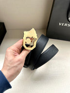 Dark blue leather belt with gold Medusa emblem buckle, textured finish.