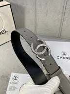 Leather belt with gray outer strap and black underside, silver-tone double C buckle with stones