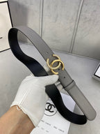 Two-tone leather belt with gold-tone double C buckle, gray outer strap and black underside