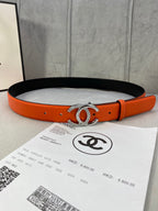 Orange leather belt with black underside and silver rhinestone CC buckle