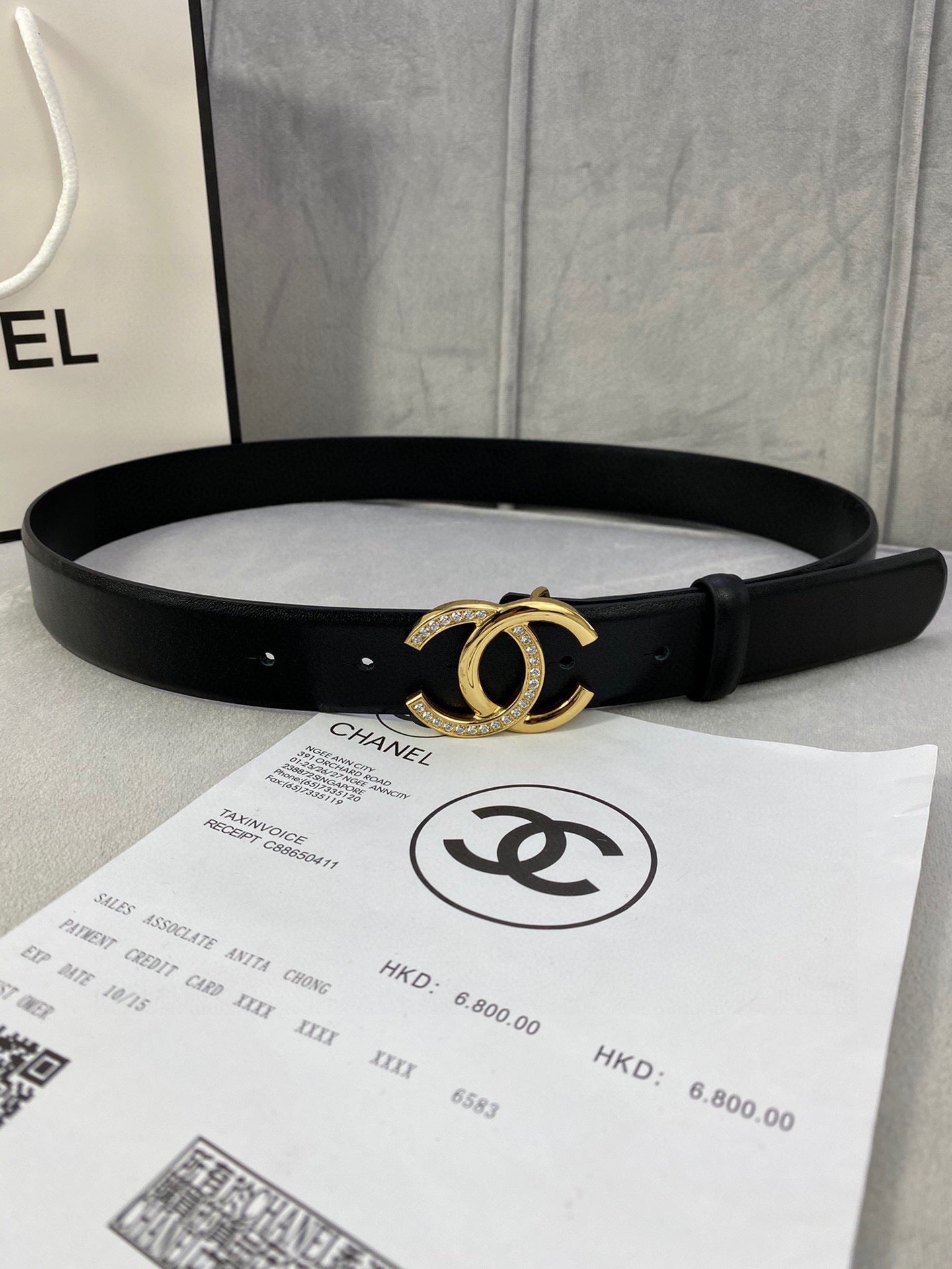 Black leather belt with gold-tone CC buckle and stud holes