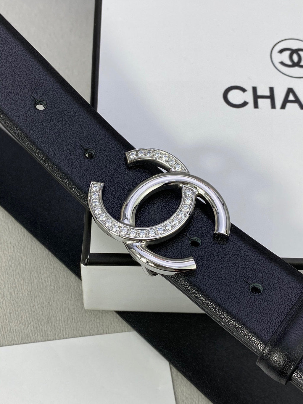 Dark blue leather belt with silver-tone CC buckle and crystals