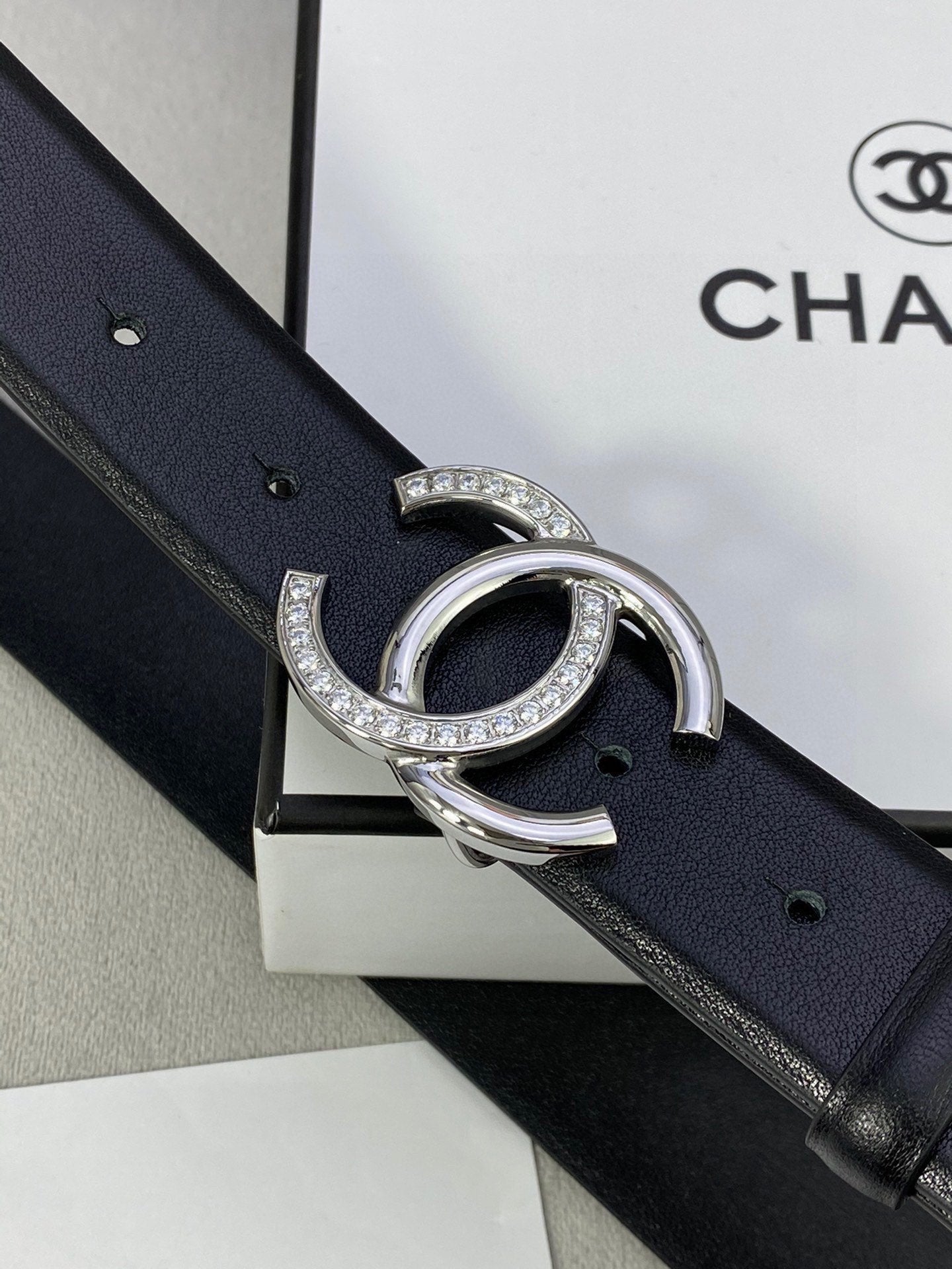 Dark blue leather belt with silver-tone CC buckle and crystals
