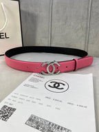 Chanel belt with pink leather strap, black underside, and gold rhinestone CC buckle