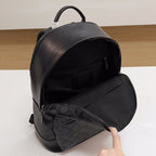 Coah backpack with open top showing inner pocket and monogram lining