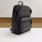 Coah backpack with monogram front panel, zip pocket, and curved top handle