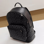 Coah backpack with curved main zipper and monogram front, dark gray