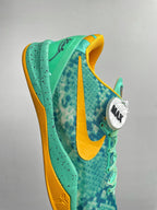 Teal basketball shoe with yellow swoosh stripe and lace eyelets, side view