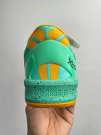 Teal basketball shoe heel with yellow insole panel and lace-up eyelets