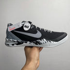 Black and white Nike basketball shoe with large Swoosh and MAX logo on heel