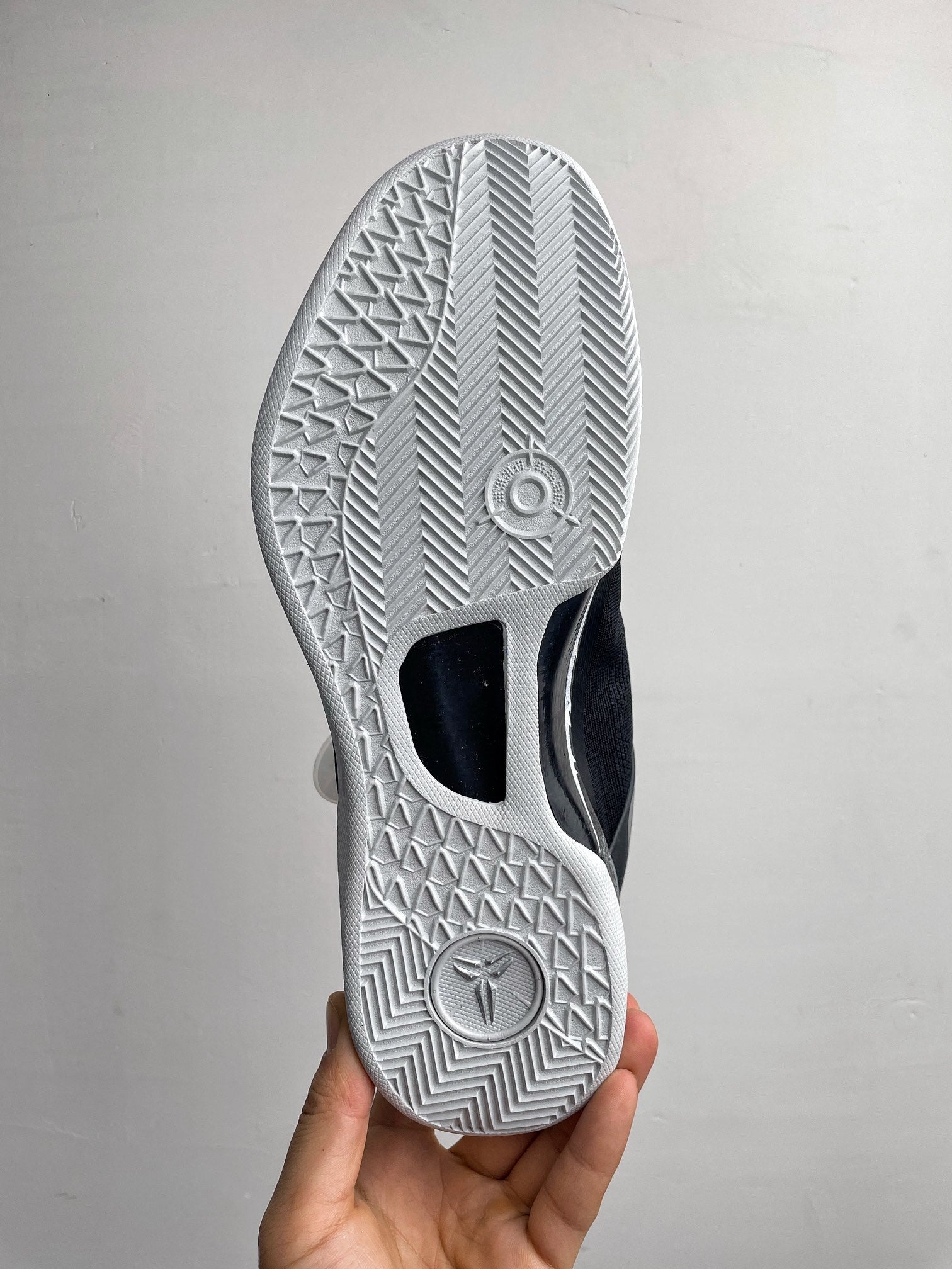 Outsole view of white and black Nike basketball shoe with chevron traction pattern
