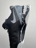 Black and gray Nike basketball shoe, side profile with Swoosh and patterned midsole
