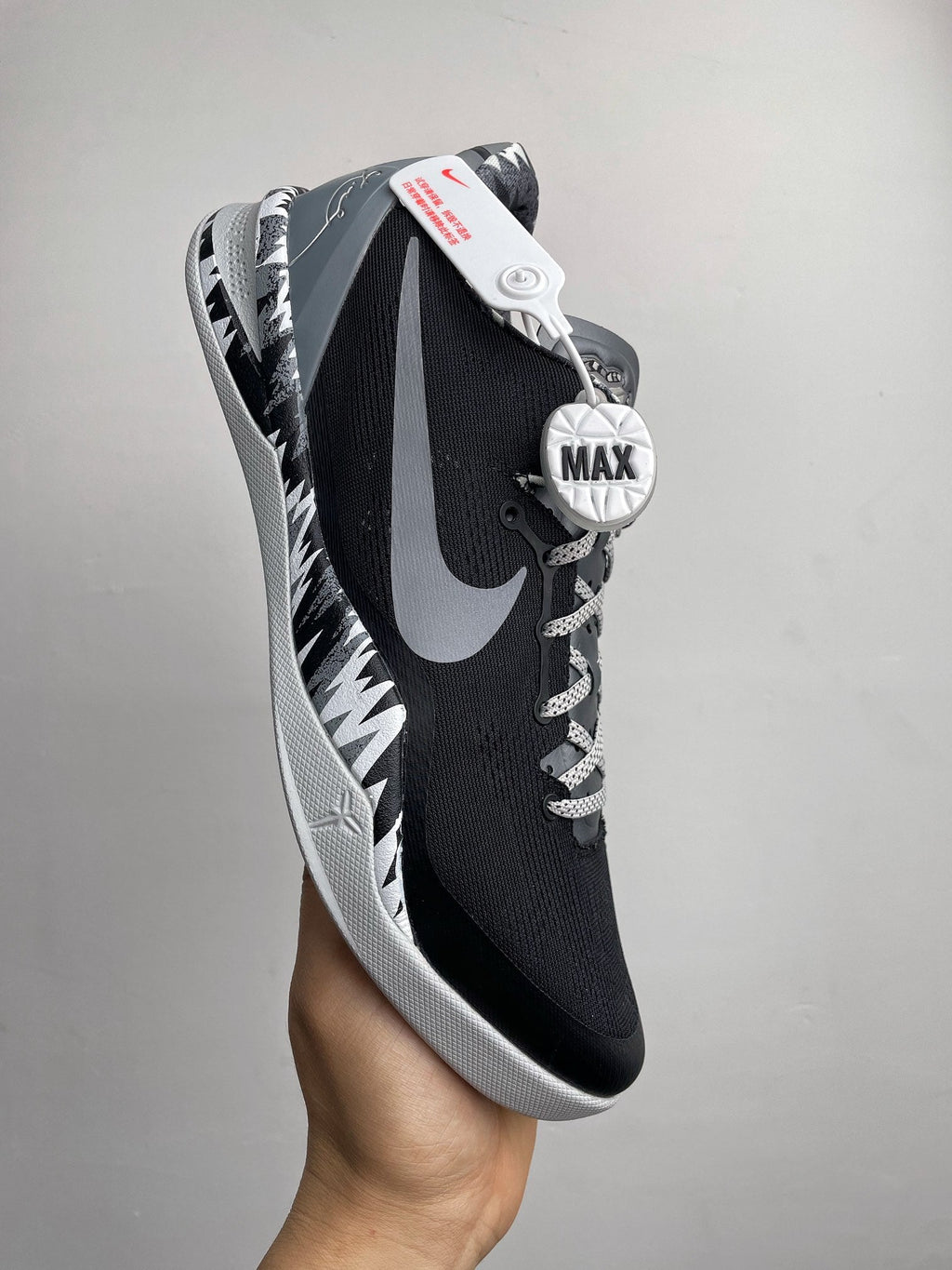 Black Nike basketball shoe with lace-up front, white Swoosh, and MAX logo
