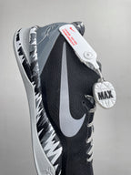 Side view of black and white Nike basketball shoe with Swoosh and MAX heel badge