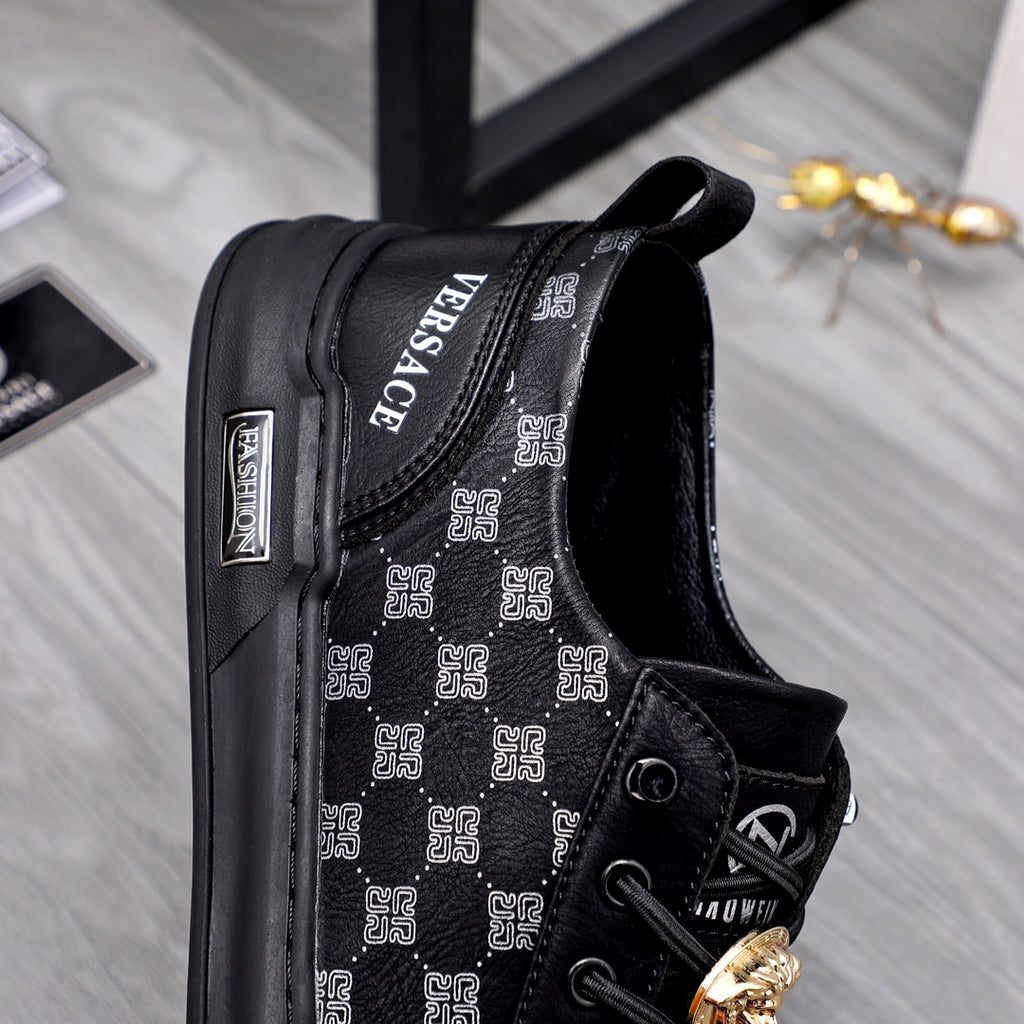Black sneakers with patterned inner side, lace-up front, gold emblem ornament detail