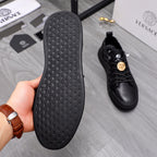 Shoe outsole and matching black sneaker; textured rubber tread bottom visible