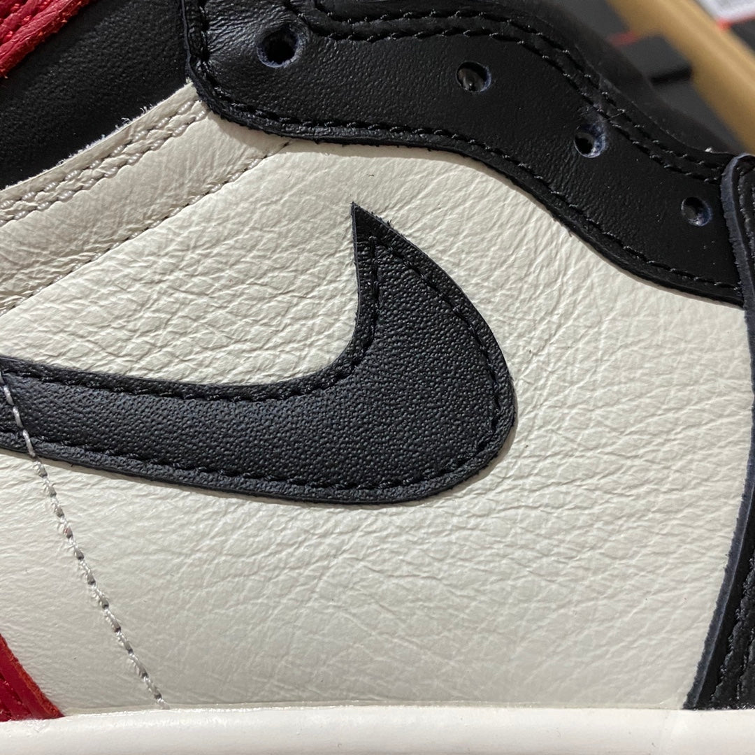 White leather sneaker quarter with black Nike Swoosh and black stitched lace edge.